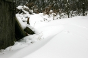 Eddies of wind around outbuildings leave deep drifts of snow